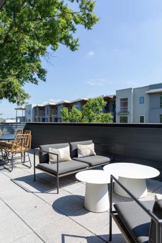 a patio with couches and tables on a building at Inkwell Charlotte in Charlotte