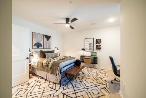 a bedroom with a bed and a ceiling fan at Inkwell Charlotte in Charlotte