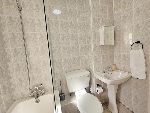 a bathroom with a toilet and a sink at Dolphin Nook 29 in Gqeberha