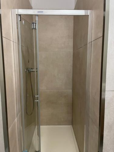 a shower stall with a glass shower door at Casa Della Baia With a beautiful view in Varazze