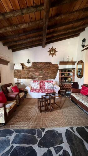 a living room with a couch and a table at Monte da Freira in Bencatel