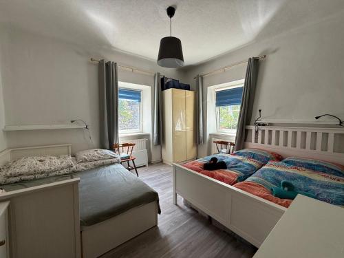 a bedroom with a bed with a cat laying on it at Nest Salzkammergut- Cozy Stay in Bad Aussee, Near Hallstatt - Garden & BBQ in Bad Aussee