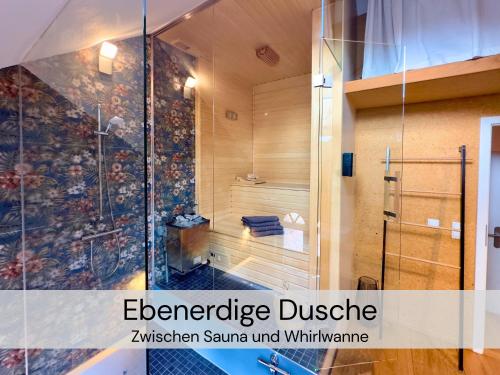 a shower with a glass door in a bathroom at HexenburgbeiDresden 2 Zimmer Architektenwohnung mit eigener Sauna, Whirlwanne und Kamin - Nähe Sächsische Schweiz Dresden in Großharthau