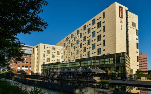 a large building with a restaurant in front of it at Hotel Artemis Amsterdam in Amsterdam