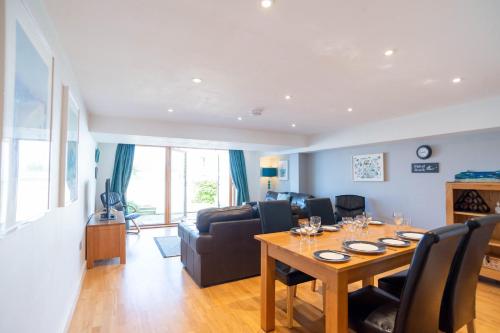 a living room with a table and a couch at Fistral Beach Garden Apartment 3 in Newquay