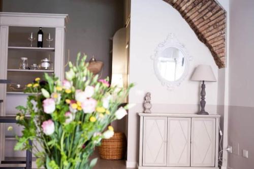 a vase of flowers on a table in a room at Trastevere Little Home in Rome