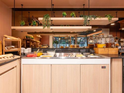 a large kitchen with a lot of food at Novotel Macon Nord - Porte de Bourgogne in Mâcon
