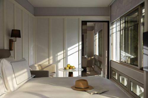 a hotel room with a bed with a hat on it at METT Singapore in Singapore