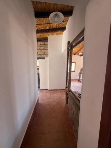 a hallway in a house with a mirror at El Patio in Purmamarca