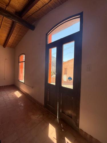 an empty room with a door and a window at El Patio in Purmamarca