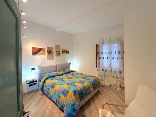 a bedroom with a bed with a colorful comforter at Casa Siena Piazzetta in Siena