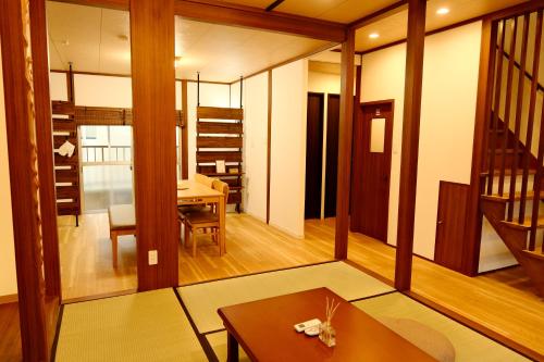 a living room with a table and a dining room at Out of Office Hostel by 旅路 in Fukuoka