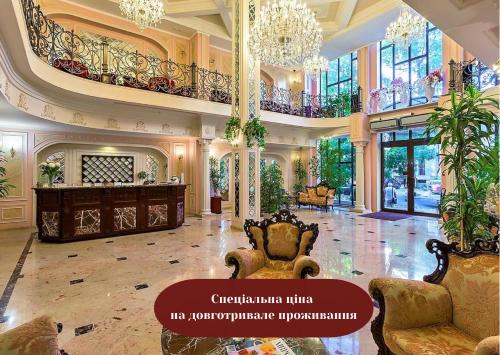 a large living room with chairs and a chandelier at Boutique Hotel California in Odesa