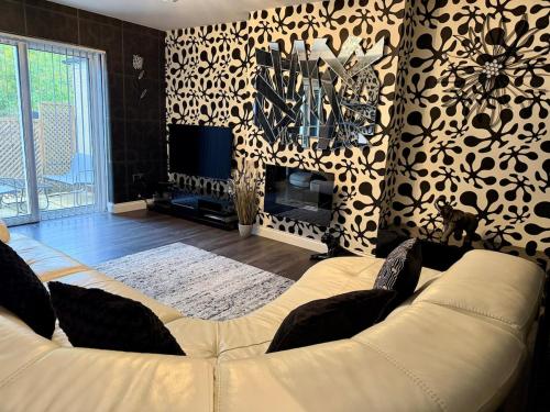 a living room with a couch and a fireplace at Stylish 3-Bed Family Pet-Friendly Home with Garden in Cardiff