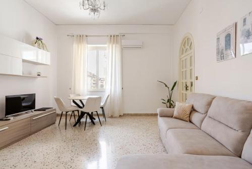 a living room with a couch and a table at Dolce Sicily a 1km dal centro in Palermo