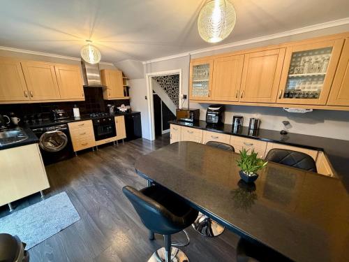 a large kitchen with a table and chairs in it at Stylish 3-Bed Family Pet-Friendly Home with Garden in Cardiff