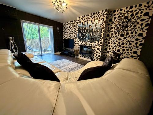 a living room with a large white couch in a room at Stylish 3-Bed Family Pet-Friendly Home with Garden in Cardiff