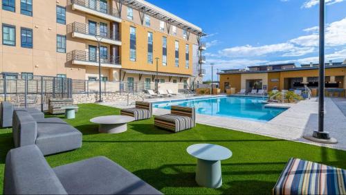 a courtyard with a swimming pool in front of a building at Landing Apartments at Ballpark Village - Goodyear in Goodyear