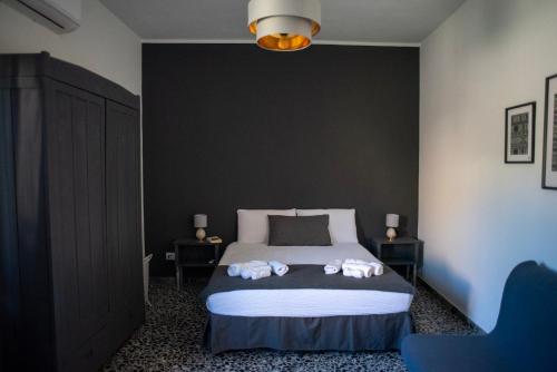 a bedroom with a bed with two towels on it at Casa Scano in Morgongiori