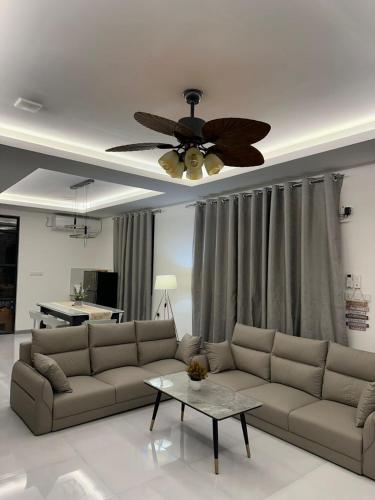 a living room with a couch and a ceiling fan at Fovahi shark view inn in Fuvahmulah