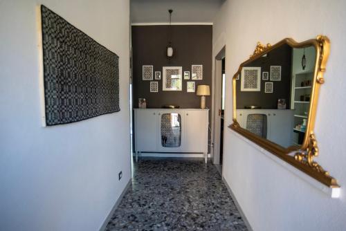 a hallway with a mirror on the wall and a room at Casa Scano in Morgongiori