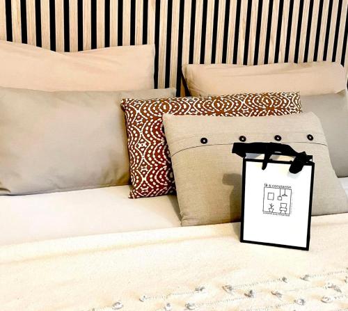 a bed with pillows and a bag on it at PULLY LAUSANNE sunny apartment on lakeside street and direct bus to Lausanne train station in Pully