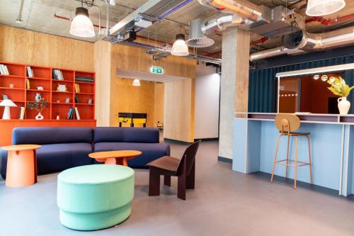 a living room with a couch and a table and stool at City View Ensuites and Studios Martha Street Glasgow in Glasgow