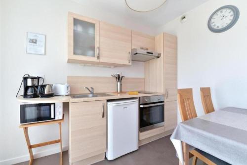 a small kitchen with a sink and a stove at Maison d'Hôtes Sainte Hune Chambres et appartements in Hunawihr