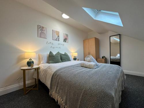Un dormitorio con una cama grande y un espejo. en Modern 1-Bed Apartment in Central Ilkeston, en Ilkeston