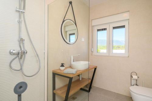 a bathroom with a sink and a mirror at Villa Zvonimir in Sreser