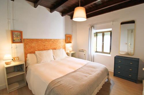 a bedroom with a large bed in a room at Resolana 26 by SIERRA VIVA in Higuera de la Sierra