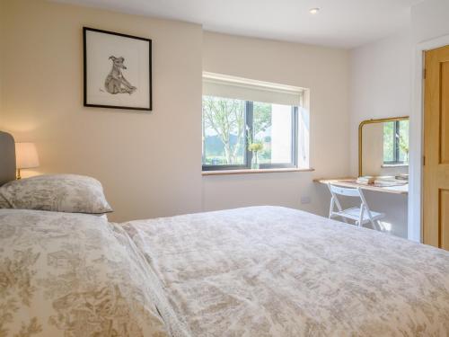 a bedroom with a bed and a window and a desk at 2 Bed in Cheriton Fitzpaine 78468 in Cheriton Fitzpaine