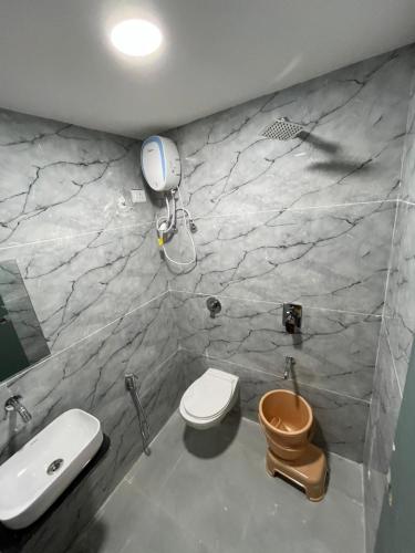 a bathroom with a toilet and a sink at Hotel Golden Park in Ahmedabad