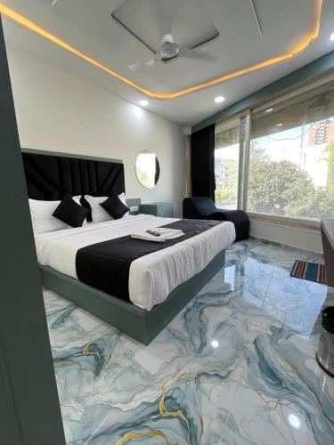 a bedroom with a large bed with a weird floor at Hotel Golden Park in Ahmedabad