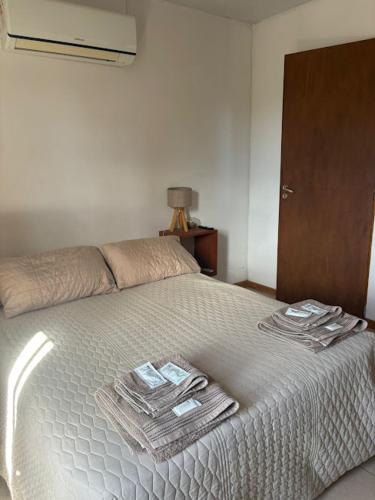 a bedroom with a bed with towels on it at Hostal El soleado in Navarro