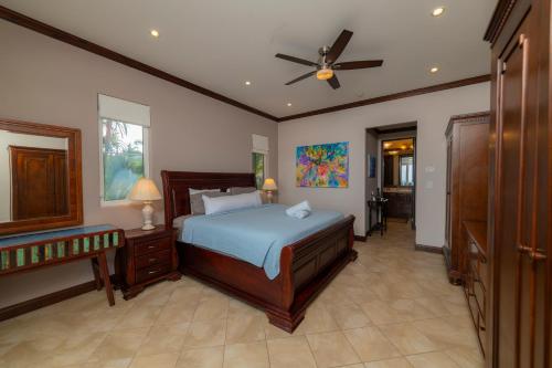 a bedroom with a bed and a ceiling fan at AltaVista 4C 3 bdr Ocean View in Los Suenos in Herradura