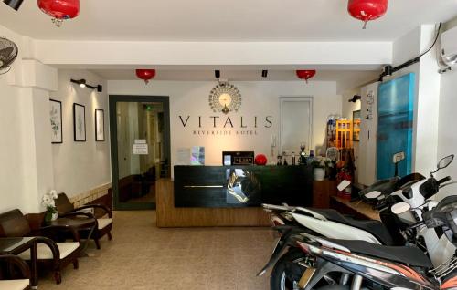 a store with a motorcycle parked in a room at Vitalis Riverside Hotel in Danang
