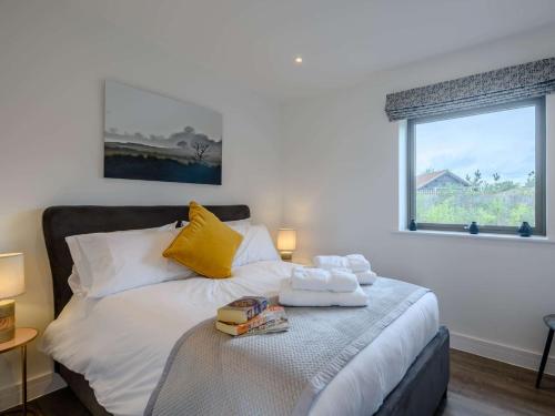a bedroom with a bed with towels on it at 2 Bed in East Bergholt 82398 in East Bergholt