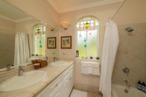 a bathroom with two sinks and a shower at Colina 8E 2 bdr Garden View in Los Suenos in Isla Herradura