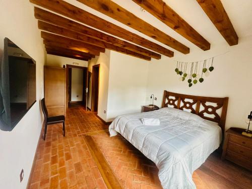 a bedroom with a bed and a chair in it at La Mansion de Gallegos in Gallegos