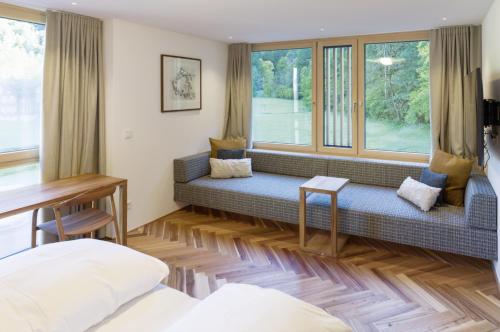 a living room with a couch and a window at Hotel Krone in Au in Au im Bregenzerwald