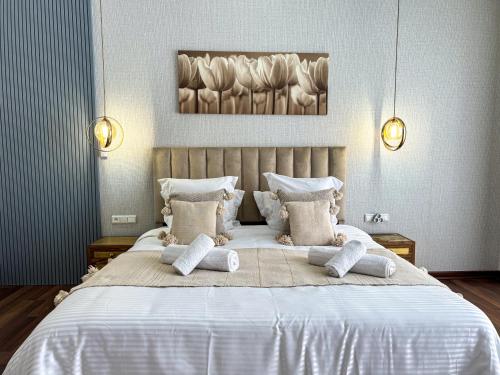 a bedroom with a large white bed with pillows at Villa Ramona in Marrakech