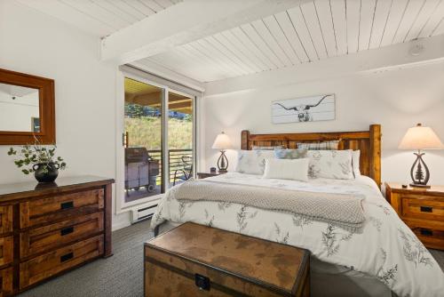 a bedroom with a large bed and a window at Enclave 209, Snowmass Ski-In/Ski-Out Condo w/Shared Pool/Hot Tub in Snowmass Village