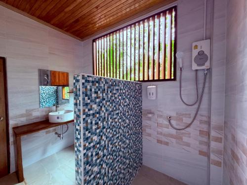a bathroom with a shower and a sink at Baantientong in Krabi town