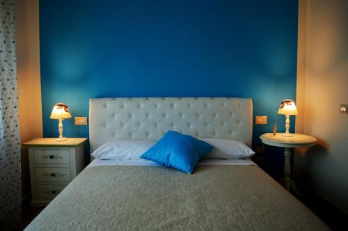 a blue bedroom with a large bed with two night stands at B&B Harmonia in SantʼElpidio a Mare