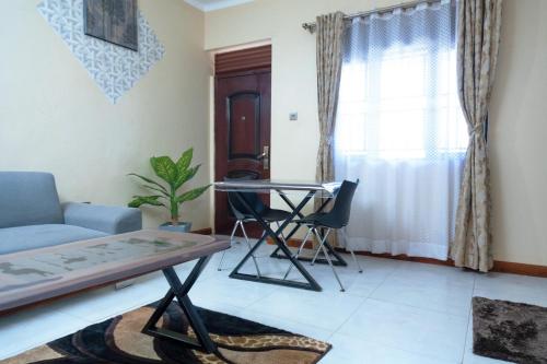 a living room with a couch and a table at A&z apartments in Namulanda
