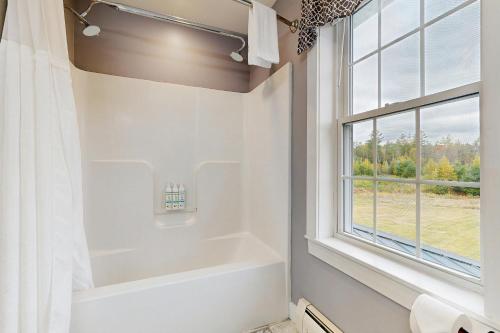 a bathroom with a bath tub and a window at Martin Grandview Estate in Lancaster