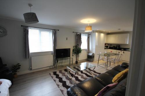 a living room with a couch and a table at Holden Court Apartments -Apt 4 in West Drayton
