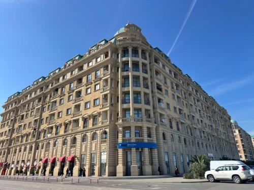 a large building with cars parked in front of it at 2-Bedroom Apartment in Sumqayyt