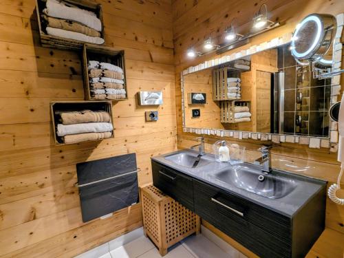 a bathroom with a sink and a mirror at Chalet Neuf Haut de Gamme avec Spa, Sauna et Décoration Originale – Gérardmer - FR-1-589-80 in Gérardmer